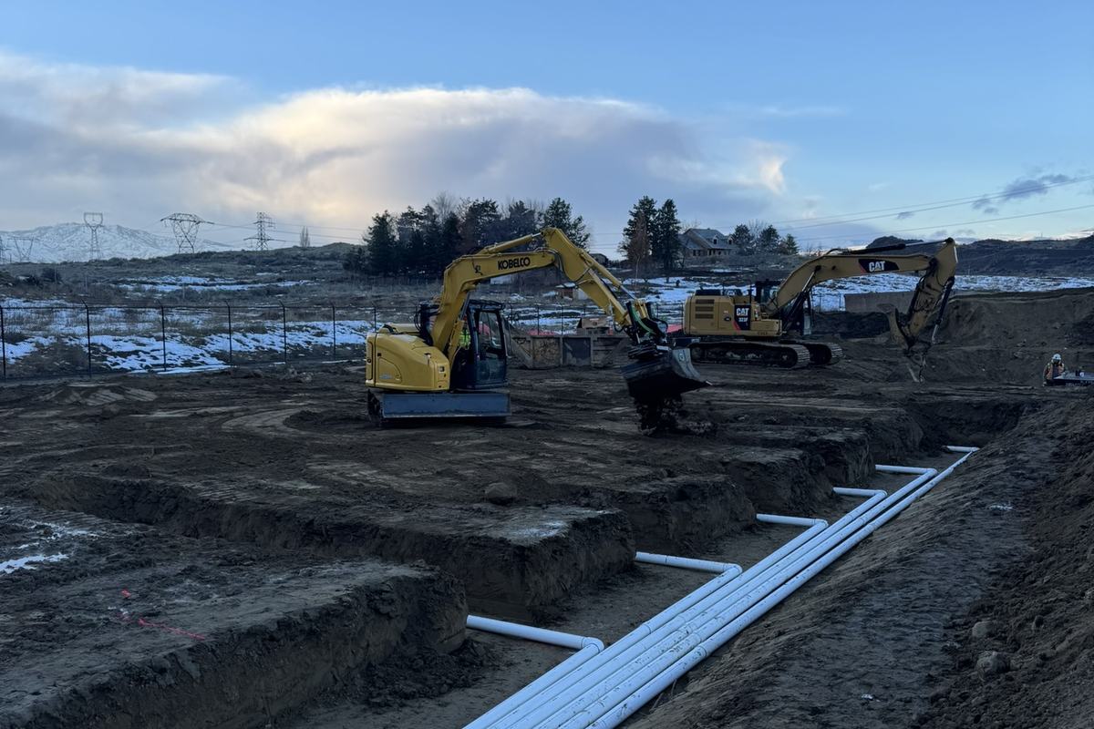 Wide view of a data center campus with pipe staged and machines working
