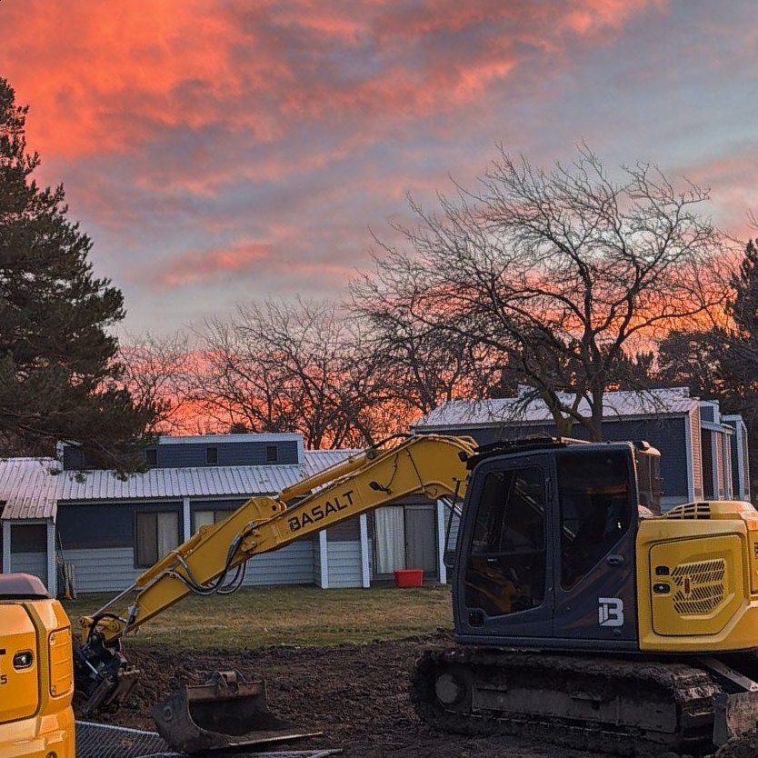 Basalt excavators on a job site at sunset