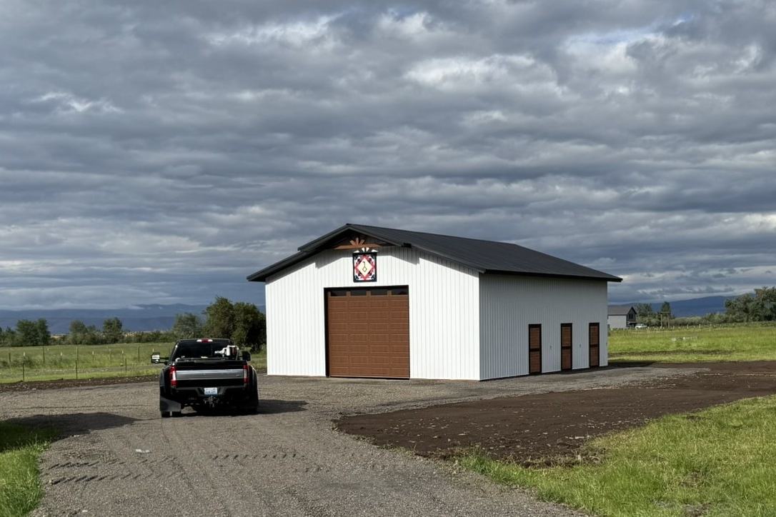 Finished gravel drive leading to a shop building