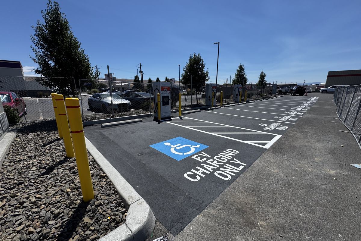 Painted EV charging stall with accessibility symbol and bollards