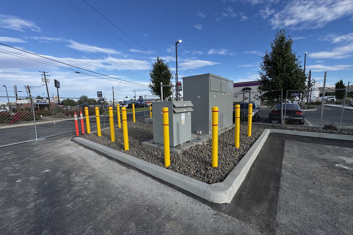 Equipment pad with yellow bollard protection