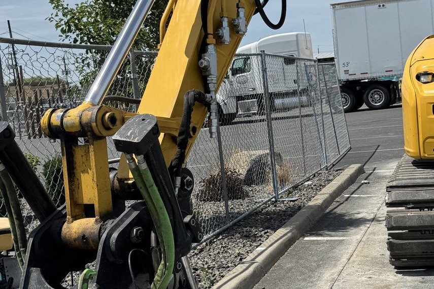 Basalt excavator with tiltrotator and attachments inside a work zone