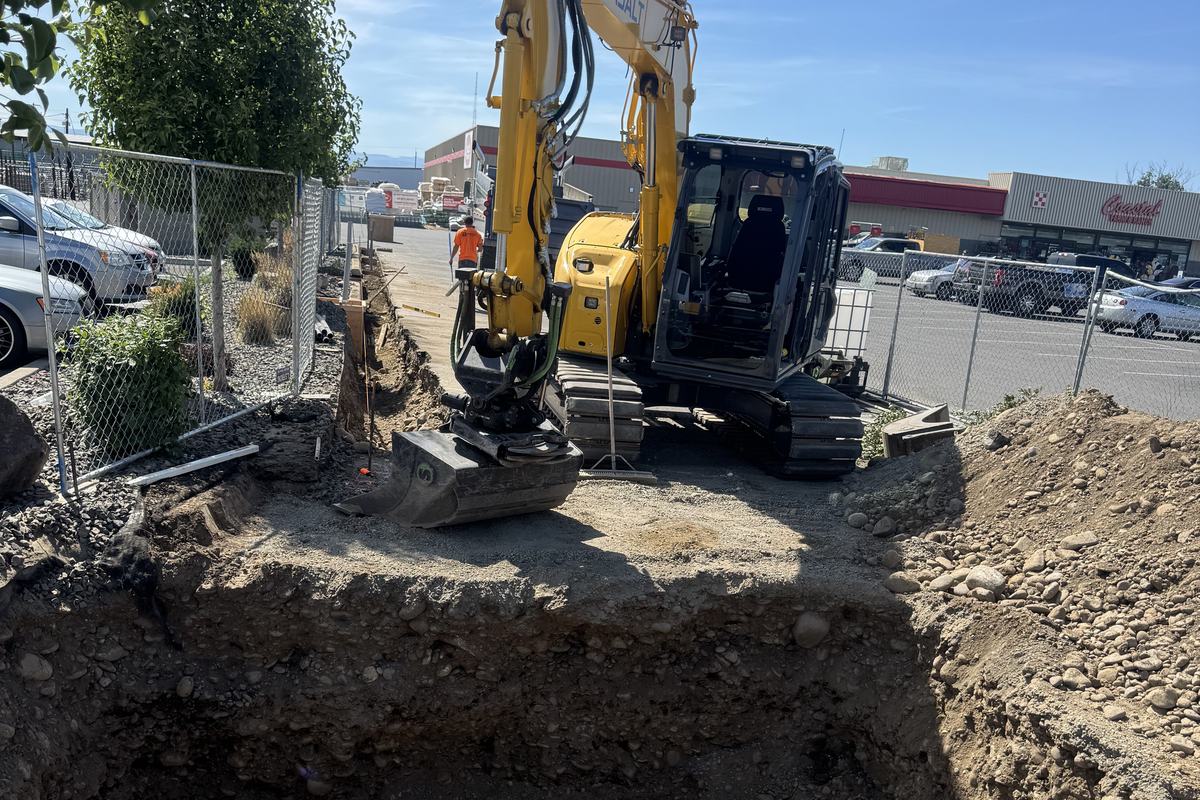 Excavator over a large excavation for a charging equipment pad