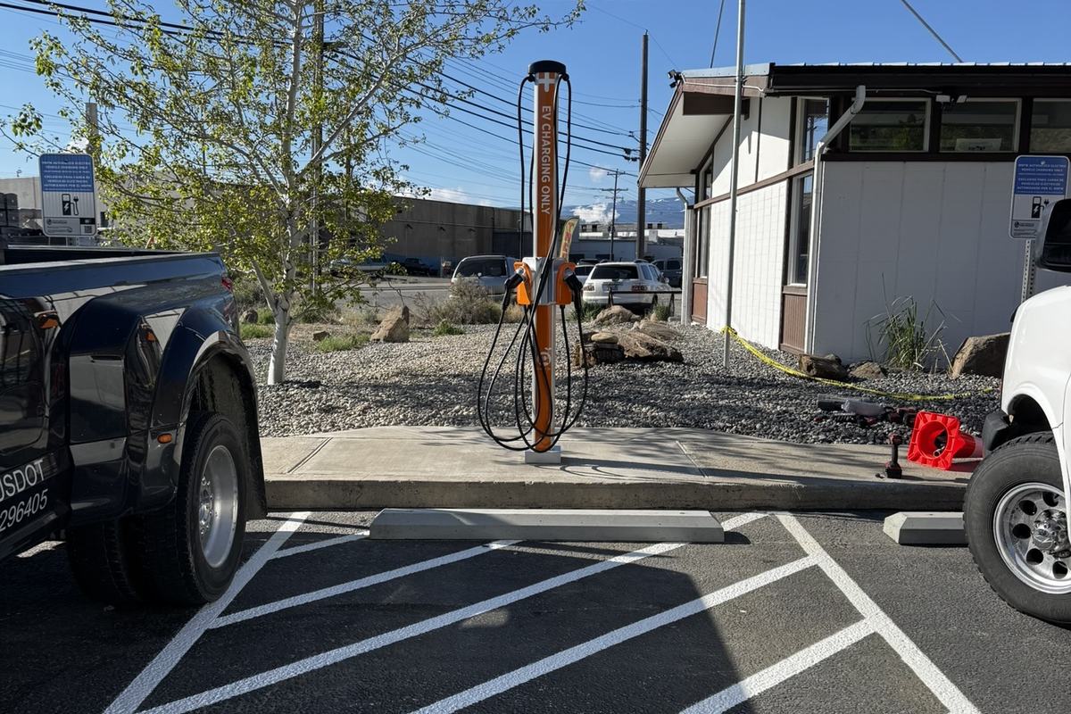 Restored and re-striped parking lot with a charging pedestal