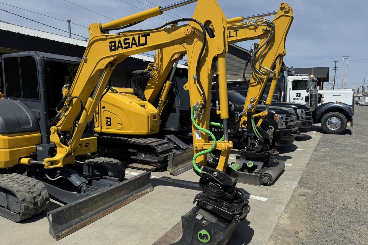 Two tiltrotator-equipped excavators, dump truck, and service trucks at the Basalt shop