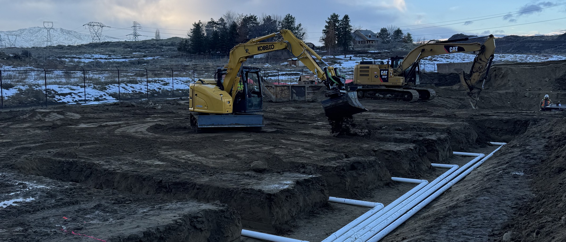 Basalt excavator and staged pipe runs on a data center campus site