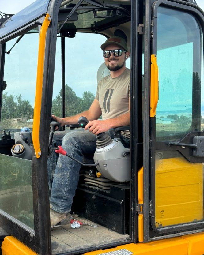Landon Carney operating an excavator